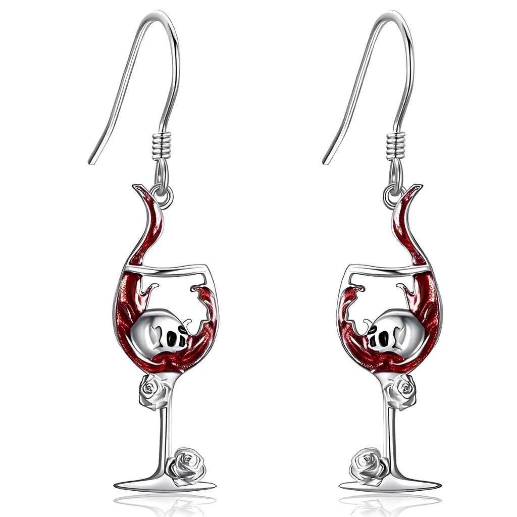 A pair of silver-toned geometric skull earrings for pierced ears on a plain background.