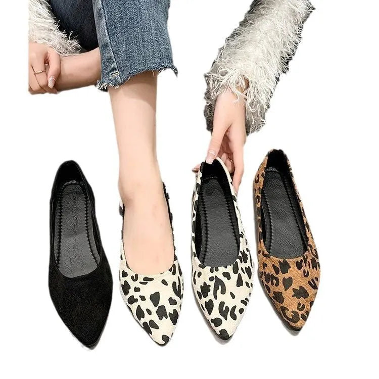 Women's leopard print flat pumps with a pointed toe and low flat heel on a rubber sole.