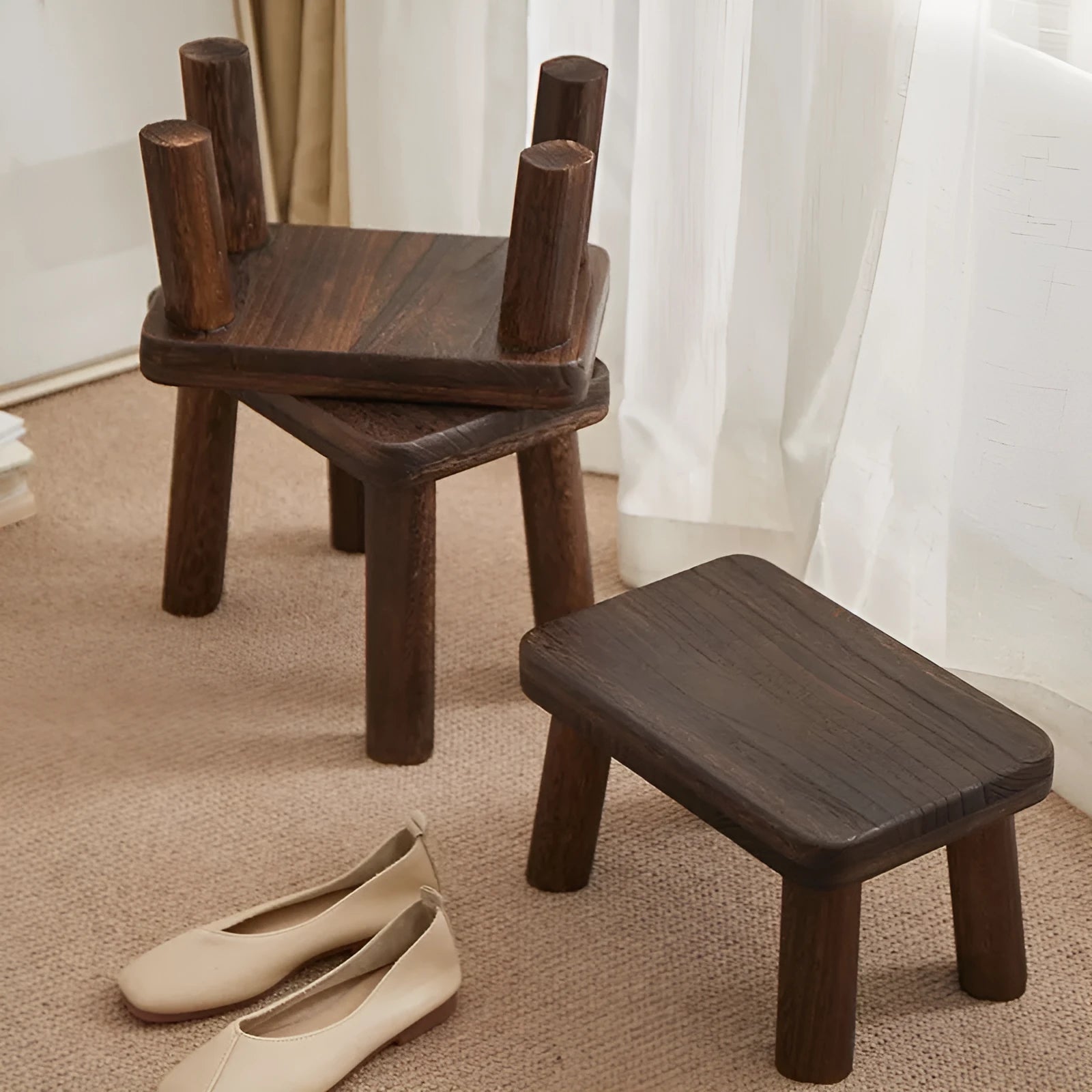 Distressed solid wood changing stool with bracket structure in a rustic finish.