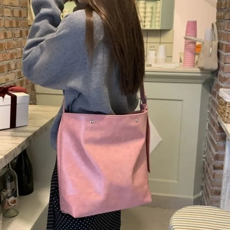 Pink and brown corduroy one-shoulder commuter bag with PU lining.