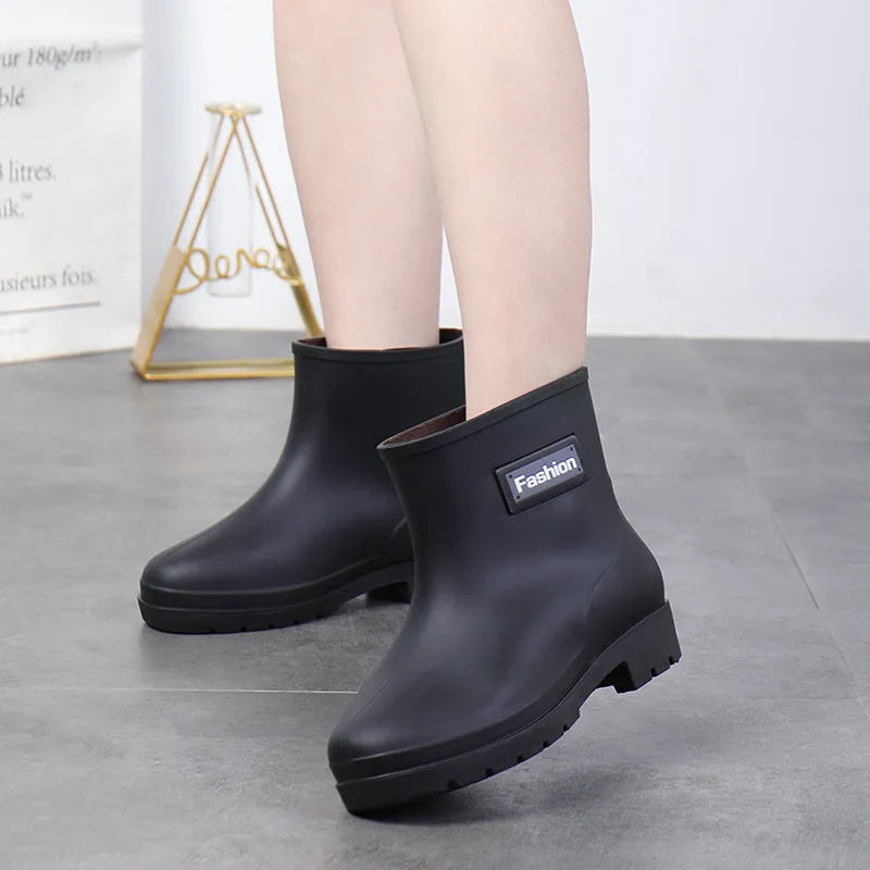 Women's mid-calf rain boot in black PVC with a low heel, shown alongside apricot and brown colour options.