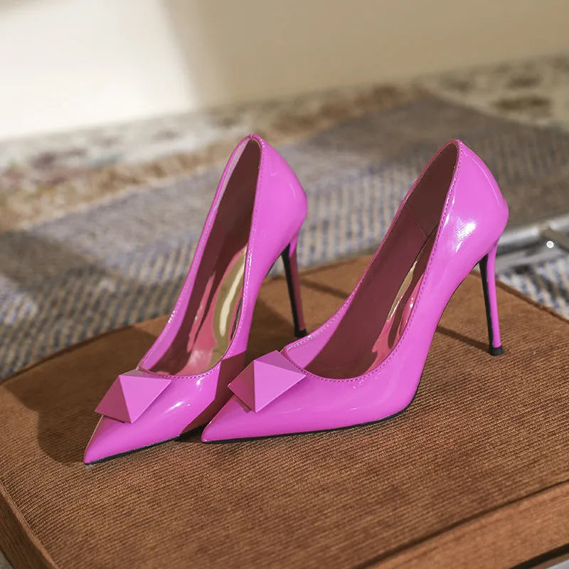 Women's pink patent leather pointed toe stiletto heels with rivet buckle decoration