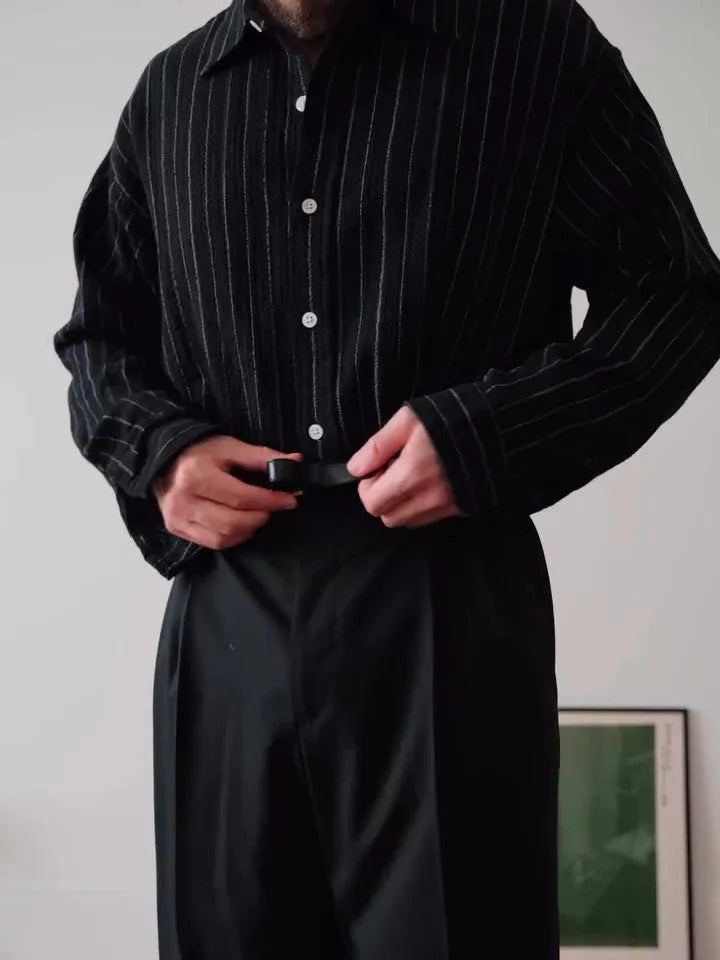 Men's black pinstriped button-down shirt with a regular fit collar on a hanger.