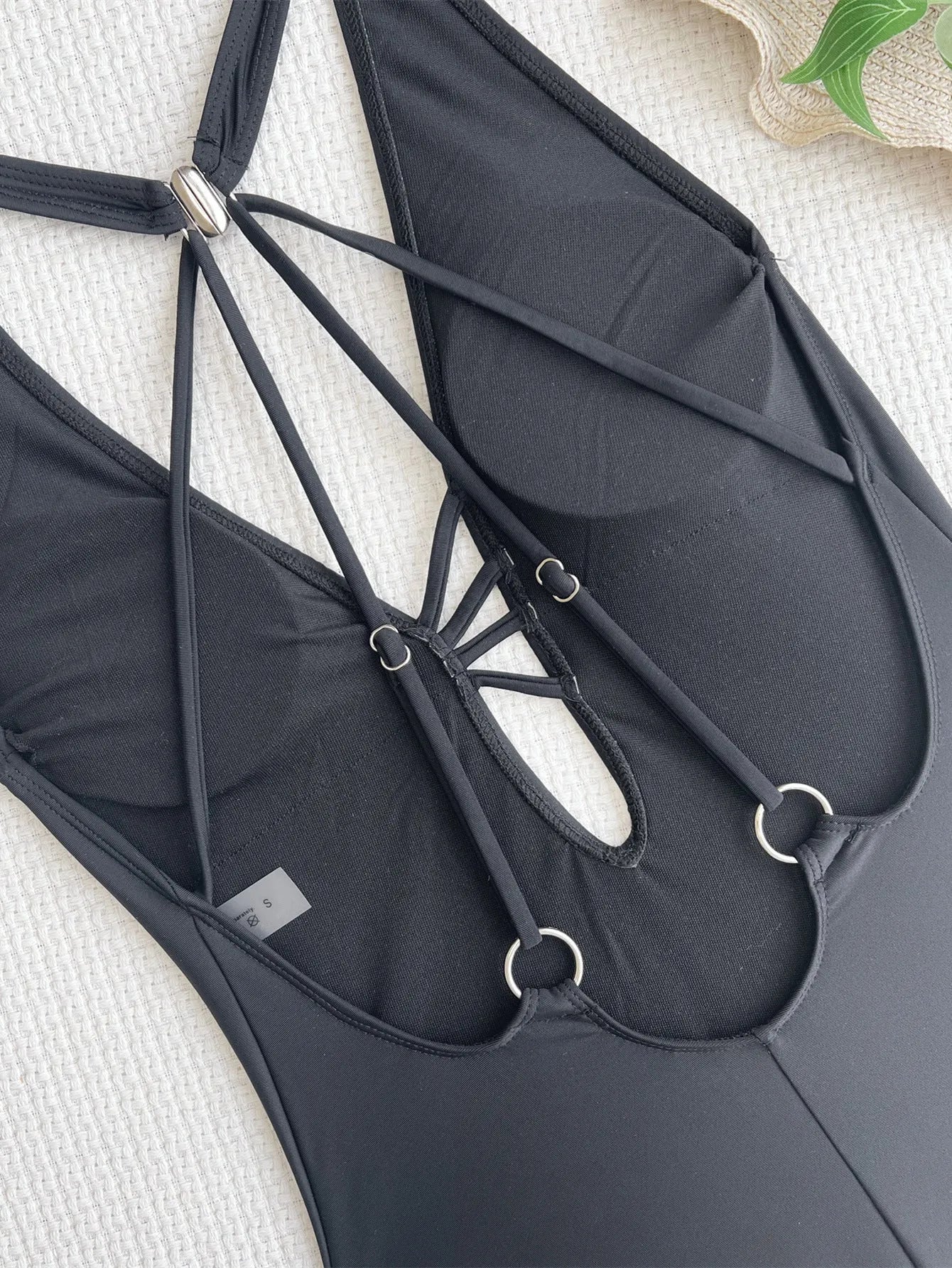 Black solid colour one-piece ladies swimsuit made from nylon fabric