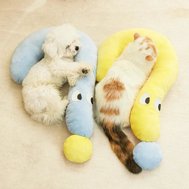 Blue rectangular pet cushion pillow for cats and dogs on a wooden floor.