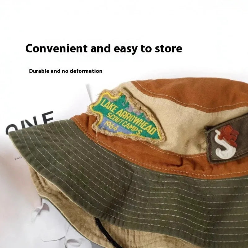 Army green cotton foldable fisherman hat with flat top crown and retro patchwork details.