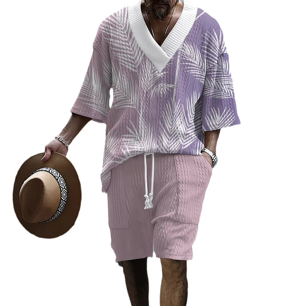 Man wearing a printed drop-shoulder knitted short-sleeve top with matching shorts in a casual setting.