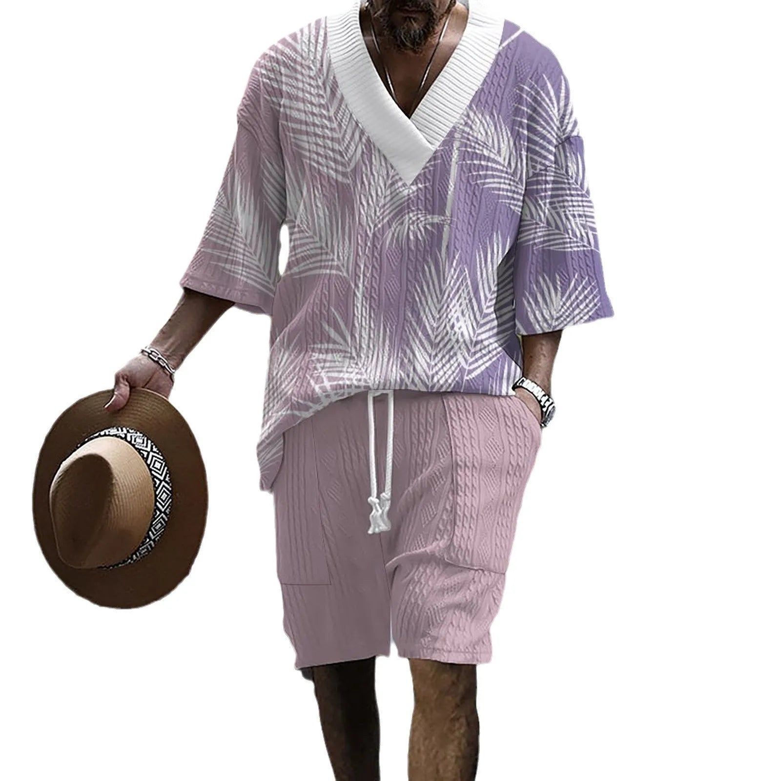 Man wearing a printed drop-shoulder knitted short-sleeve top with matching shorts in a casual setting.