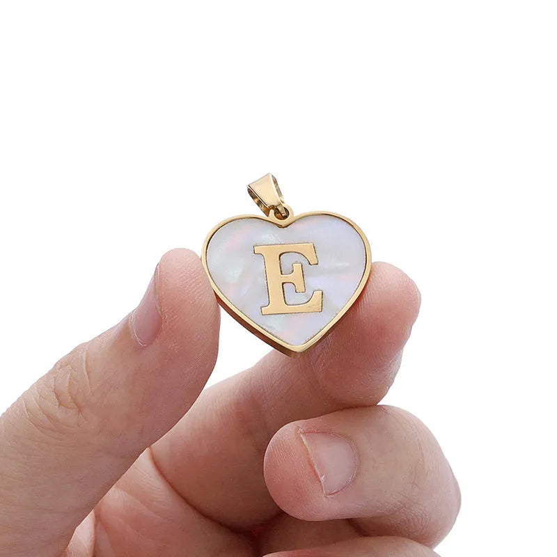 Heart-shaped letter necklace with white shell detail on gold-plated stainless steel chain