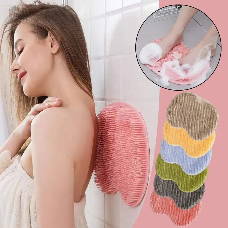 Orange silicone bristle bath brush with suction cup base on a bathroom floor