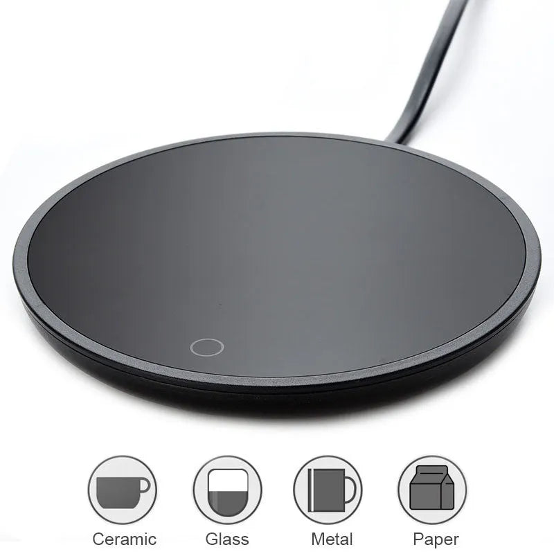 Black electric coffee mug warmer with tempered glass surface and temperature switch on a desk
