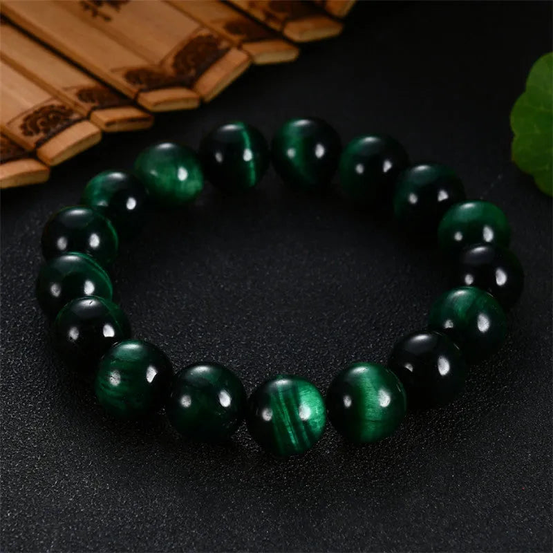 A polished green tiger eye stone bracelet with geometric beads, shown in various size options.