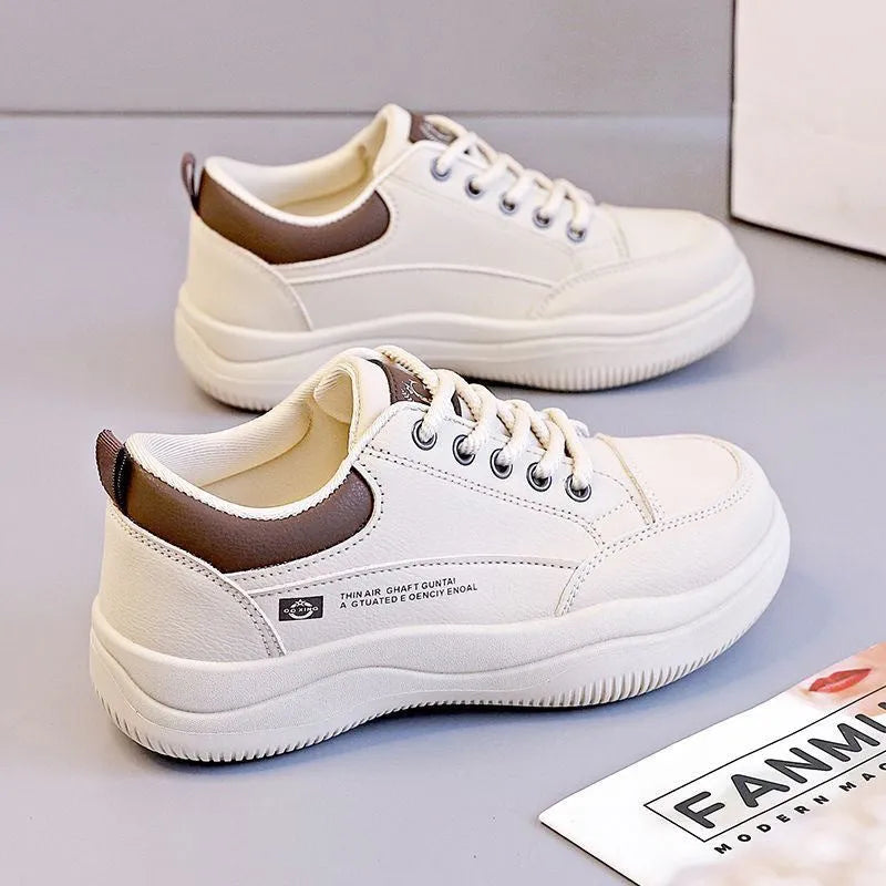 Women's white Korean-style lace-up pumps with cross straps and round toe, showing leather stitching details