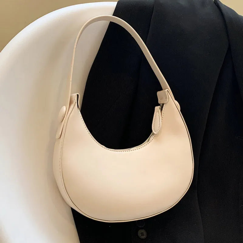 Retro dumpling-shaped women's shoulder bag in PU leather, showing sandwich pocket and cream yellow colour