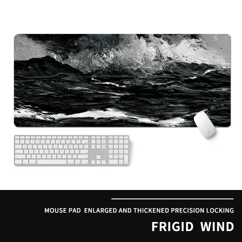 Oversized natural rubber gaming mouse pad with cold-themed graphic design showing keyboard and mouse placement