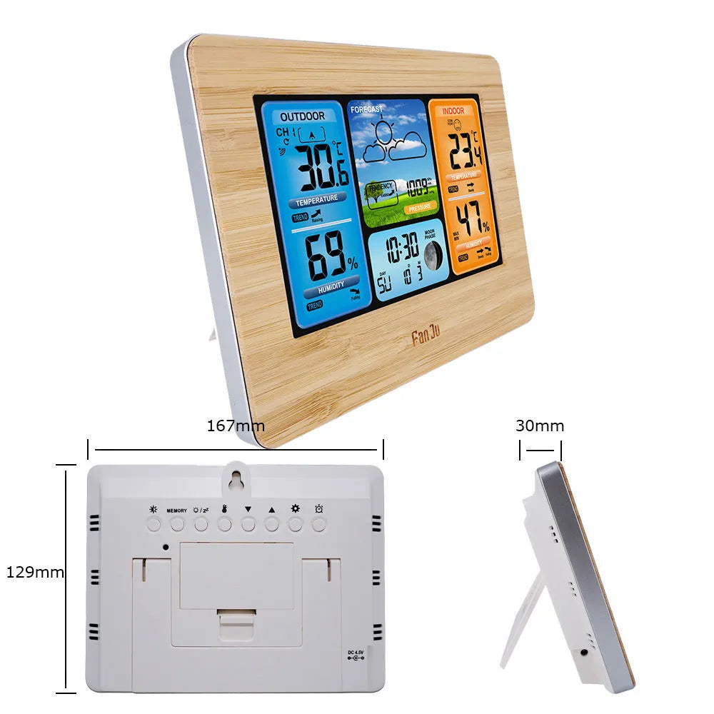 Black rectangular LCD digital weather station displaying temperature, humidity, pressure, and time on a desk.