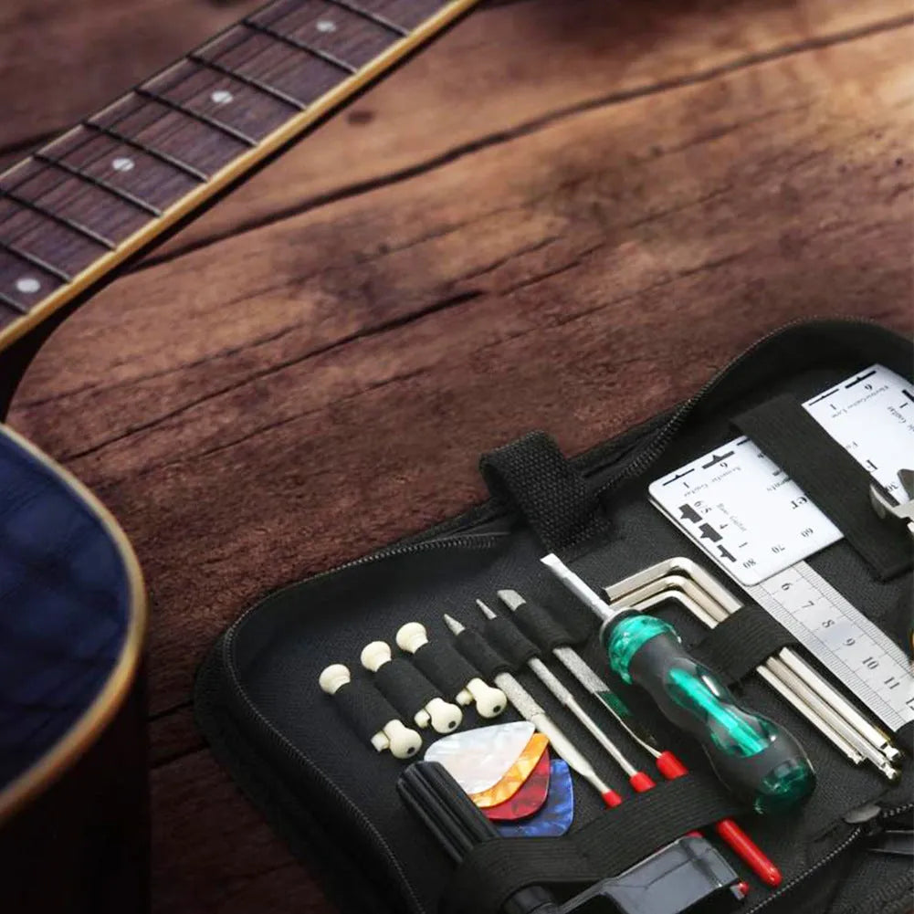 Black rectangular guitar repair tool kit case with tools for guitar, bass, mandolin, and banjo maintenance.