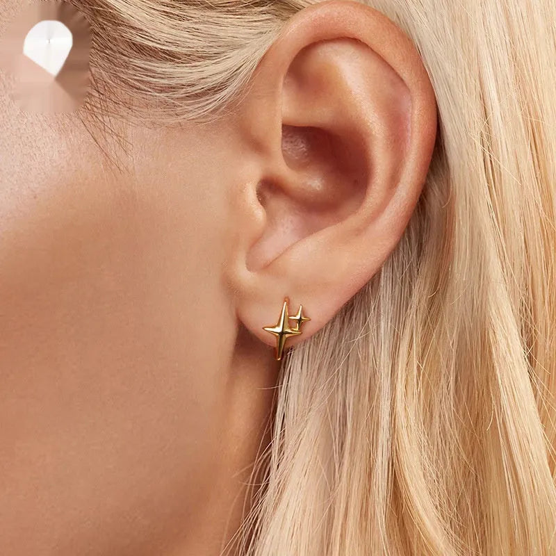 Minimalist silver star clip earrings with geometric design and oxidised finish