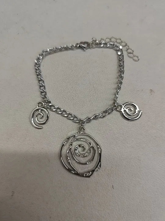 Spiral donut jewellery set showing necklace, bracelet and earrings in gold tone geometric circle design