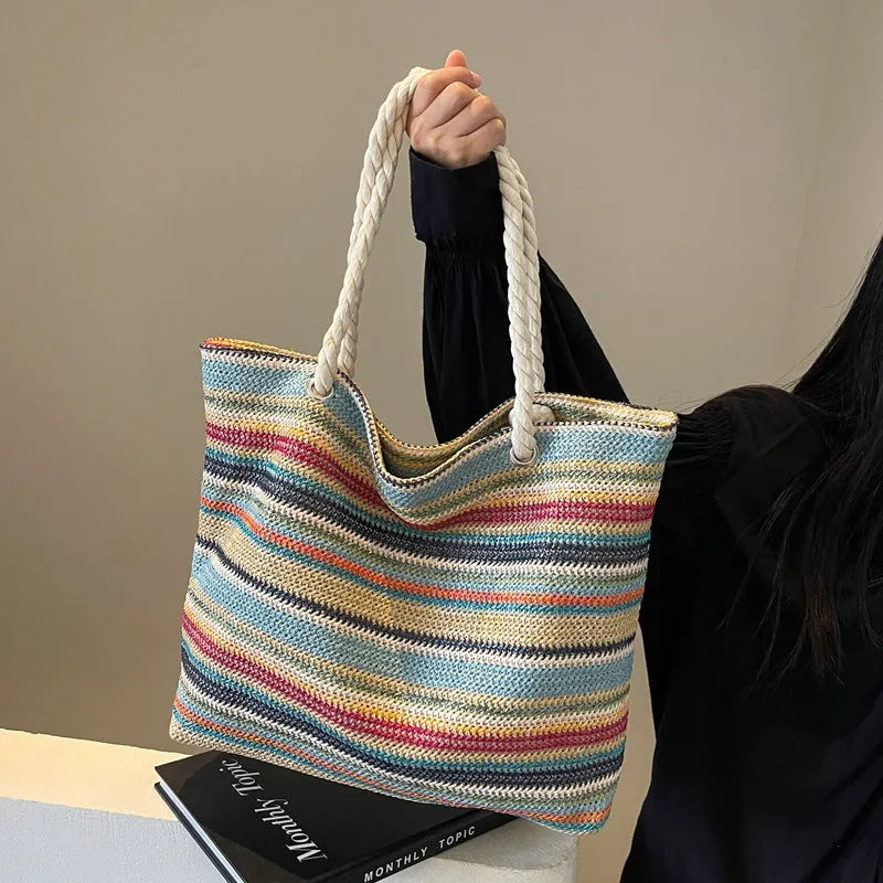 Blue woven nylon shoulder bag with adjustable strap showing straw-like texture pattern