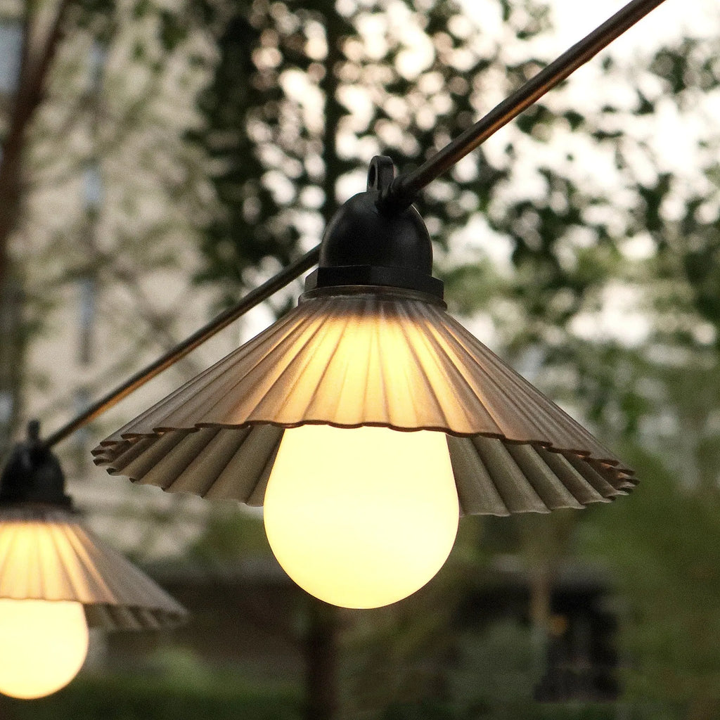 Outdoor LED string lights with flower-shaped bulbs showing IP65 waterproof rating for courtyard and camping use