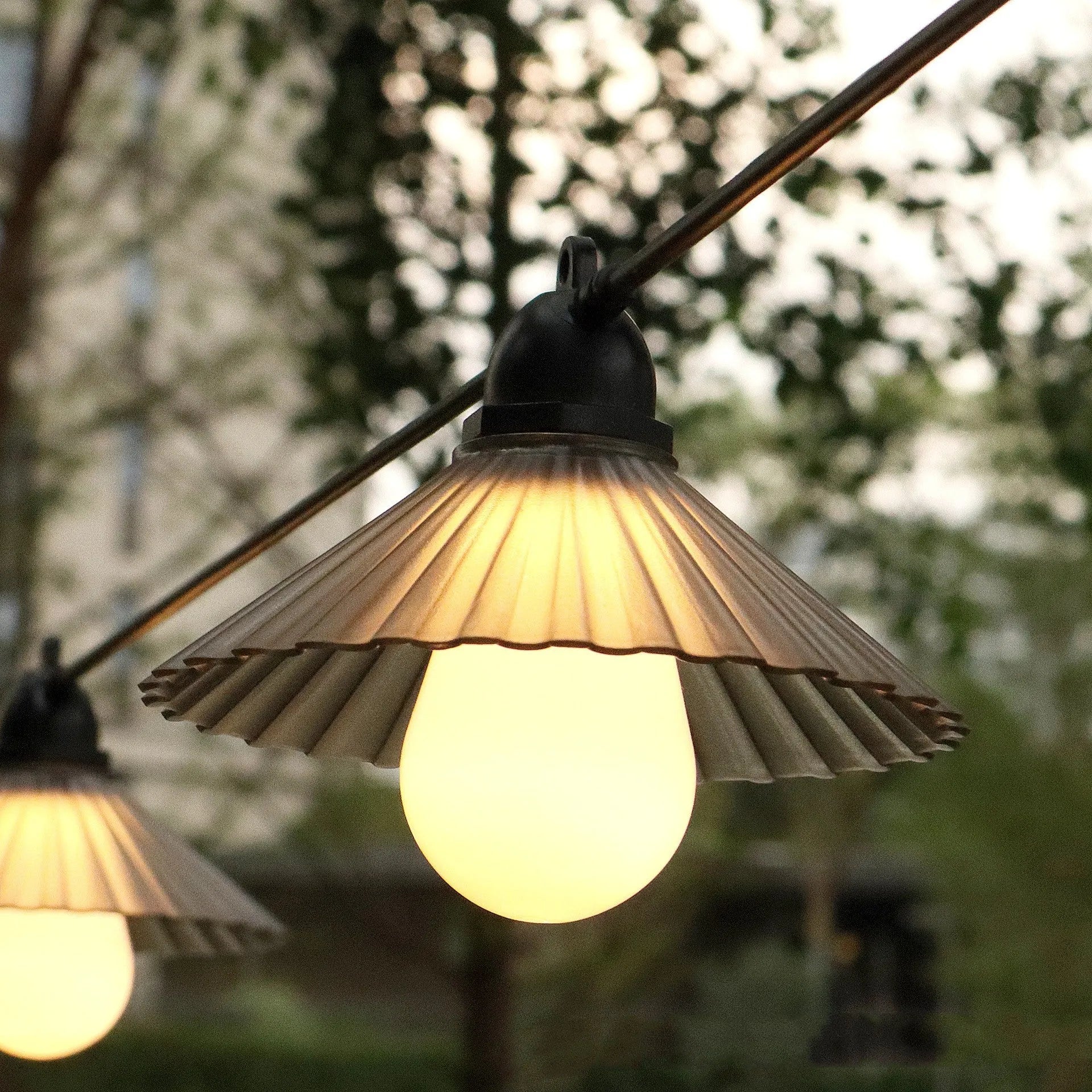 Outdoor LED string lights with flower-shaped bulbs showing IP65 waterproof rating for courtyard and camping use