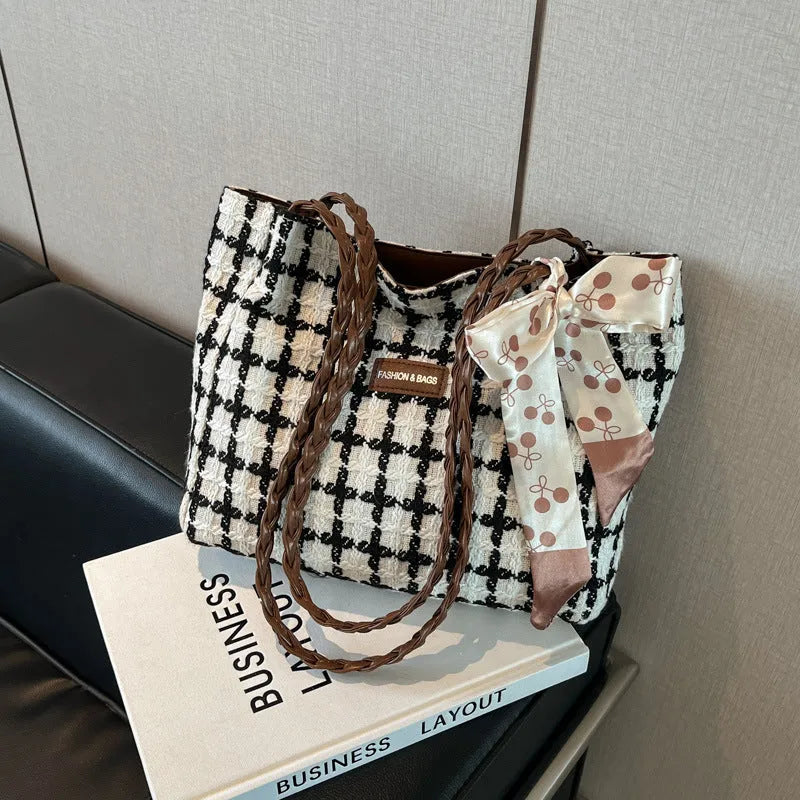 Black wool shoulder bag with horizontal square shape showing interior file compartment and phone pocket