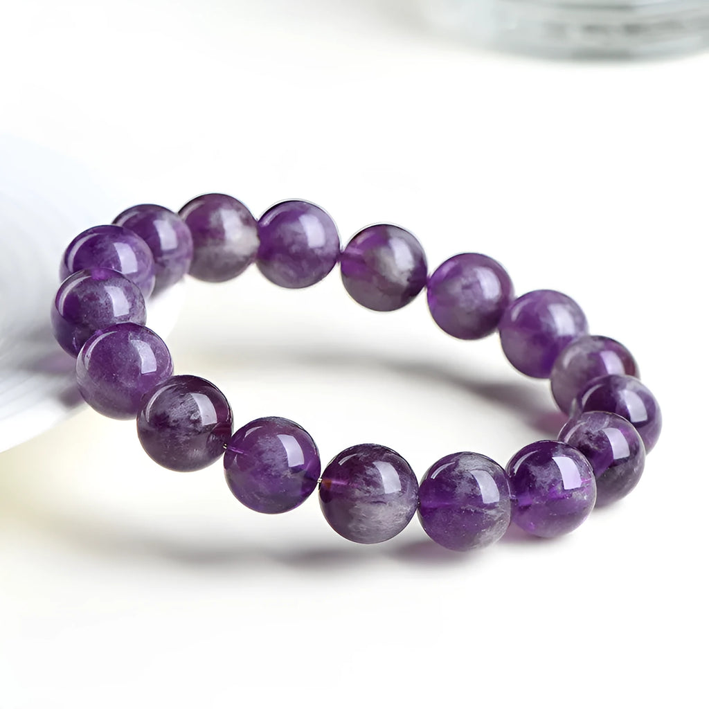 Natural feather amethyst crystal bracelet with scattered beads and Ruyi element on wrist.