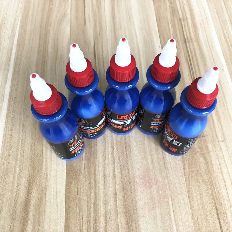 Blue car scratch repair cream bottle with applicator tool for automotive paint damage