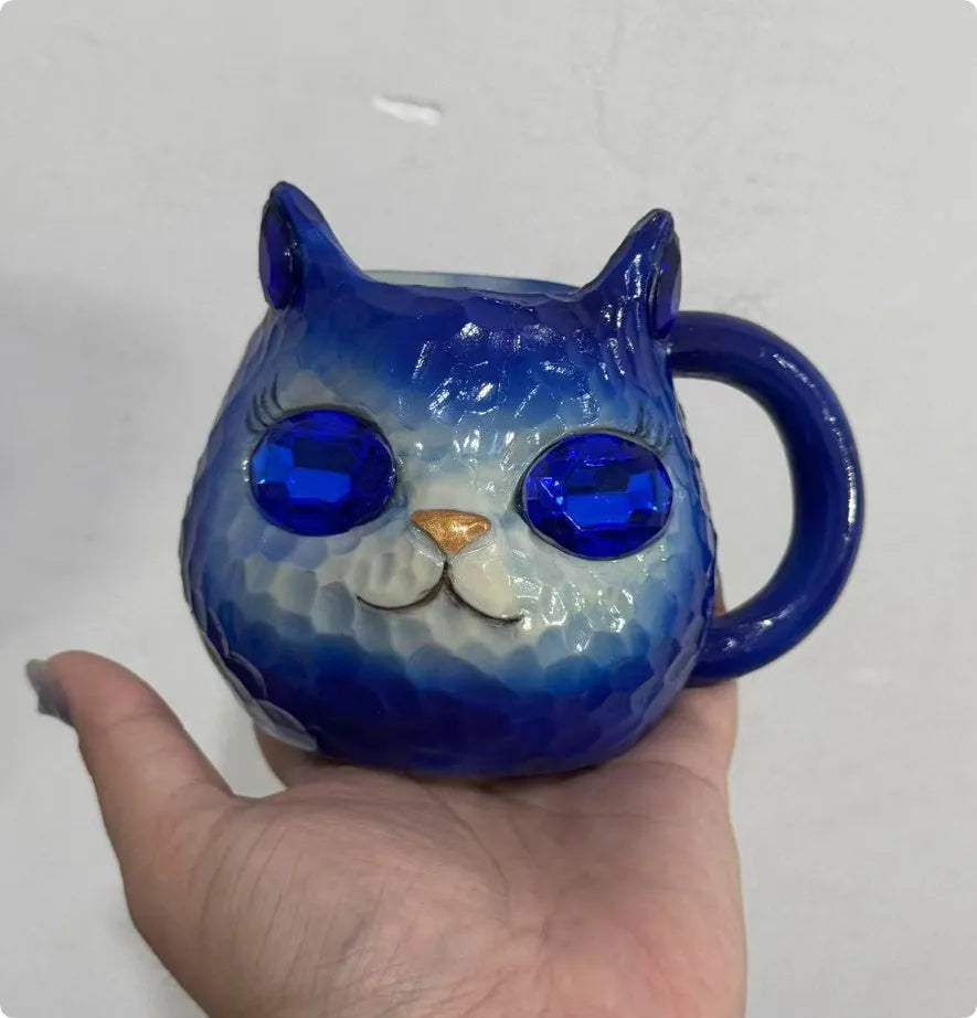 Decorative resin cat cup paperweight in American crafts style, shown in purple, green, blue, and pink colour options.