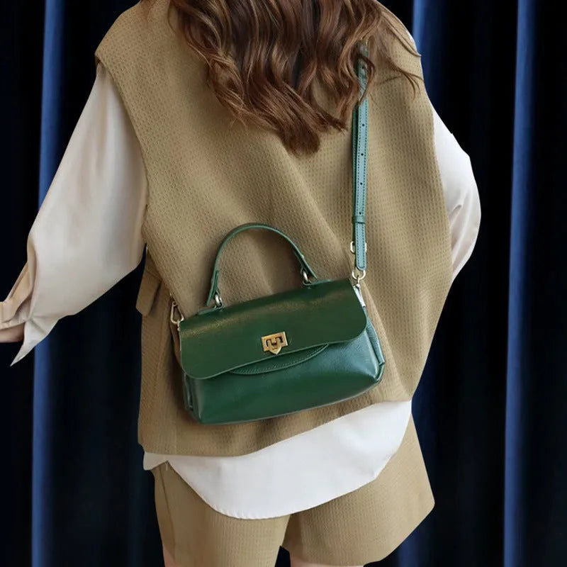 Women's dark brown genuine leather saddle back handbag with double shoulder straps showing internal organisation compartments