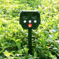 Green solar-powered ultrasonic animal repeller with motion sensor on a white background.