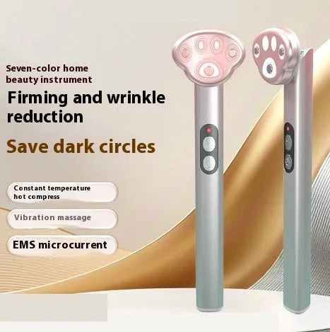 Cat's paw shaped micro-current eye massager in gradient pink with charging cable