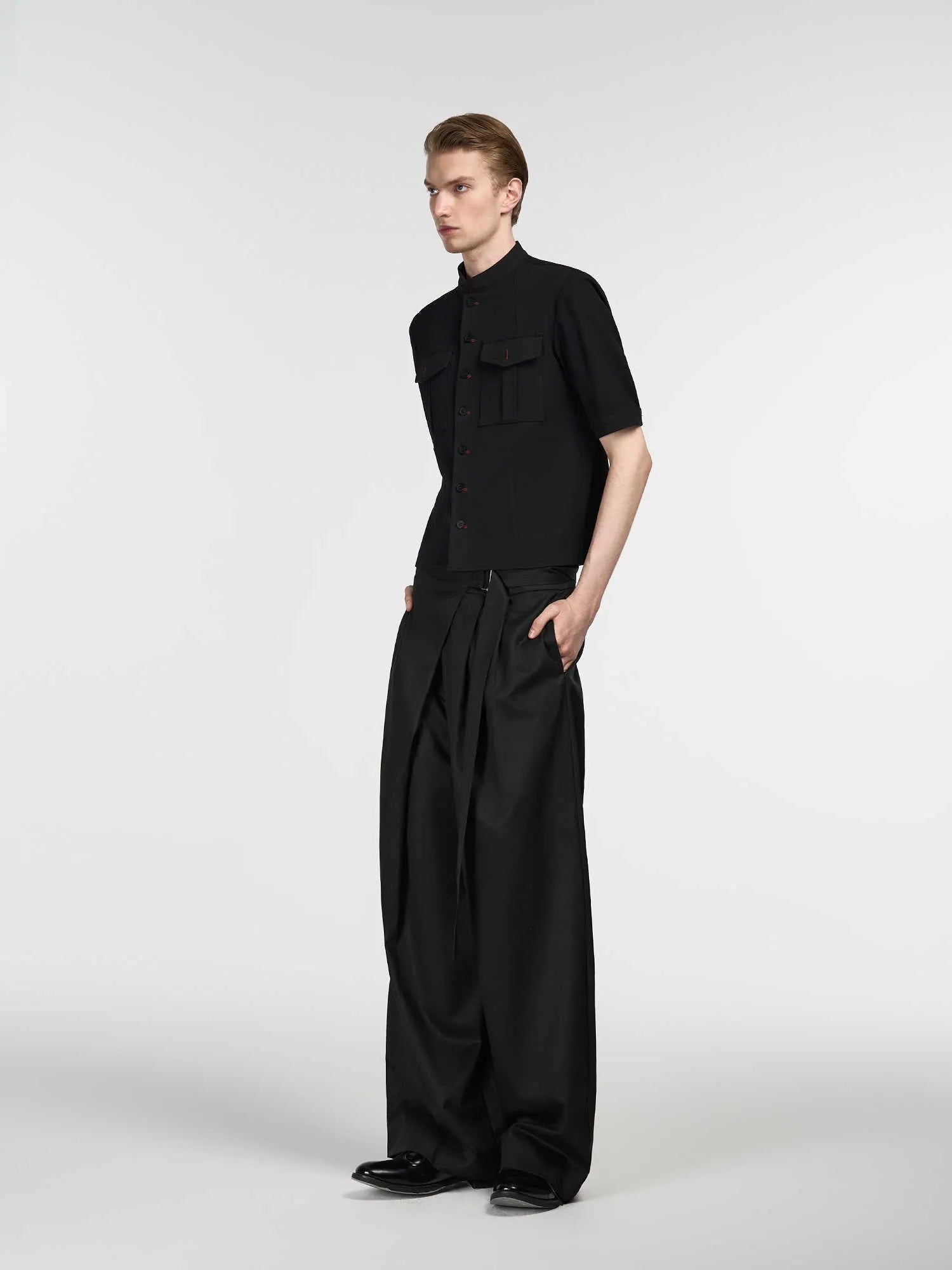 Black straight-leg women's trousers with a front pleat and adjustable waistband on a hanger.