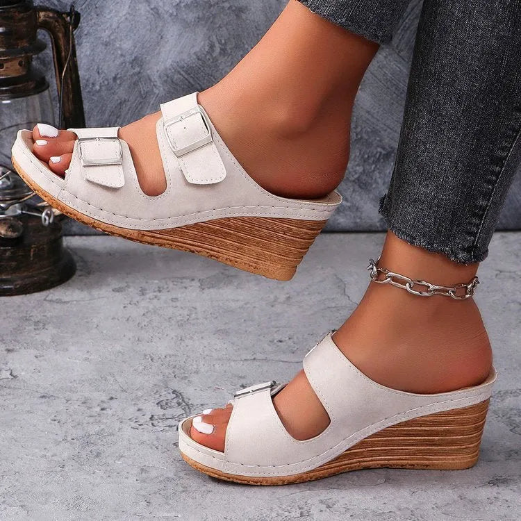 Women's creamy-white wedge beach slippers with an adjustable belt buckle strap and rubber sole