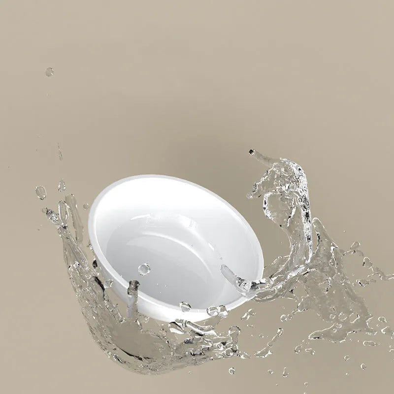 Green tilted stainless steel cat bowl with non-slip white base at a 15 degree angle