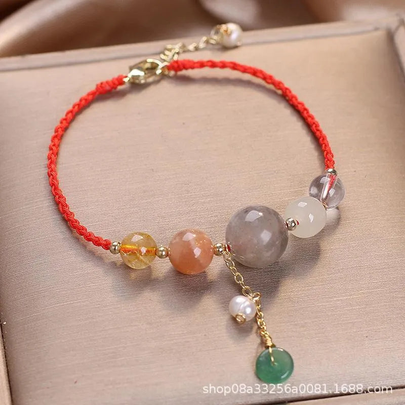 Hand-woven women's bracelet with a crystal buckle and sequins on blue string.