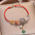 Hand-woven women's bracelet with a crystal buckle and sequins on blue string.