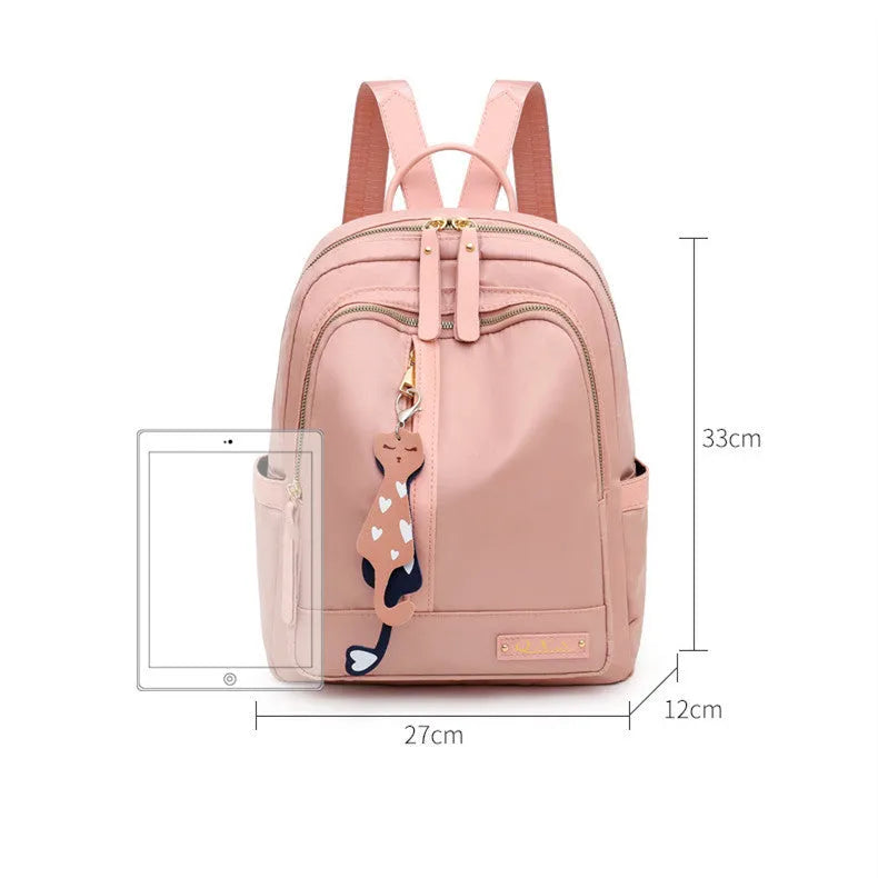 Women's casual nylon backpack in black or pink with water-resistant features and internal organisation compartments
