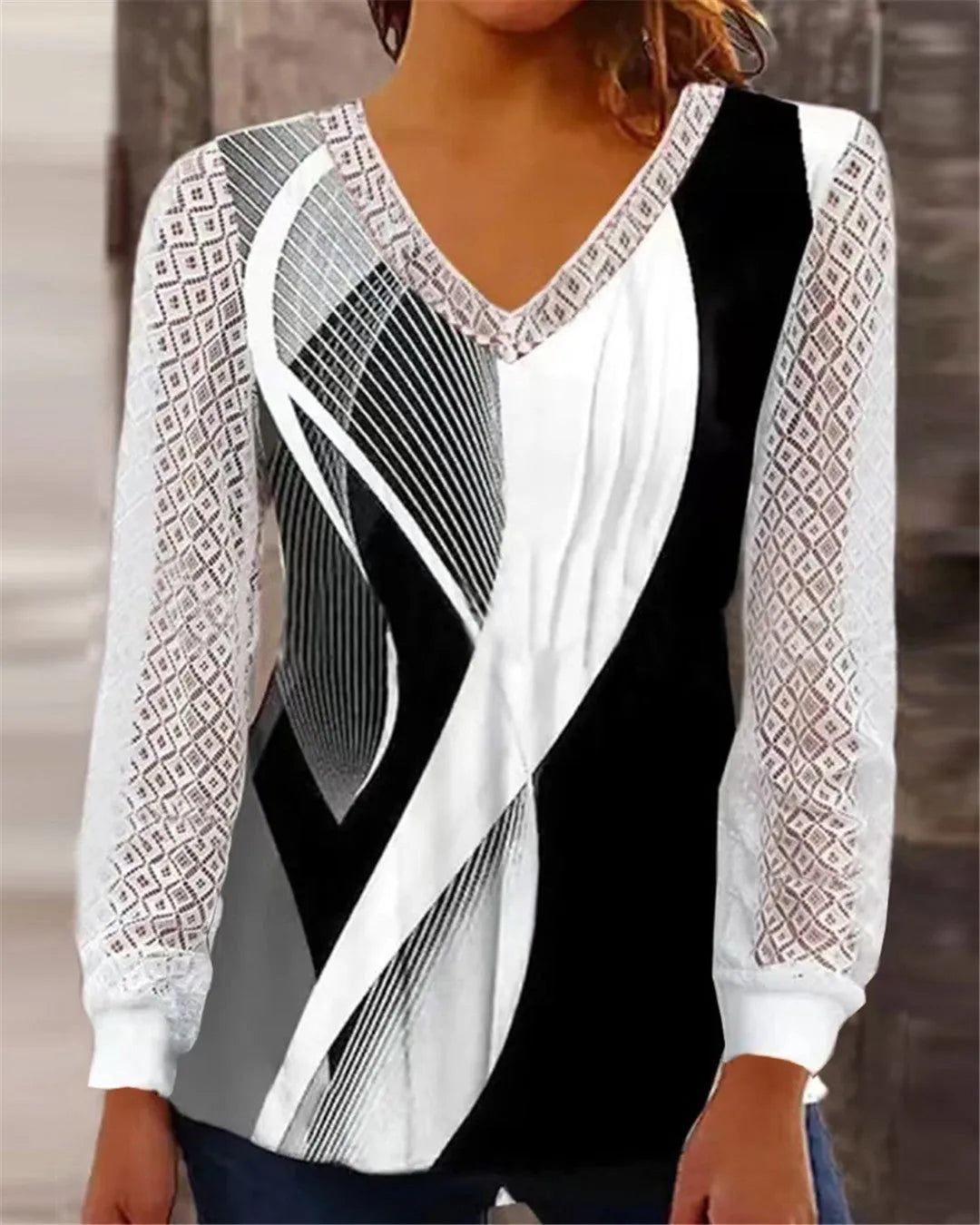 Women's loose V-neck lace top in purple with long sleeves, shown on a hanger.