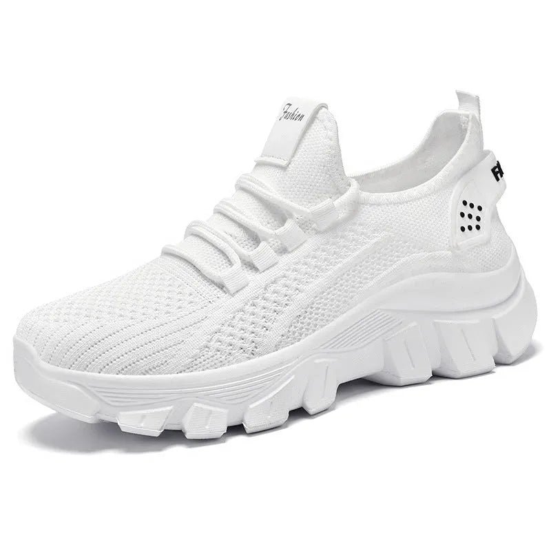 Women's white Flyknit running sneakers with lace-up front and thick PVC sole on a neutral background.