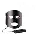 Black and white LED phototherapy face mask with controller for home skincare light therapy treatment