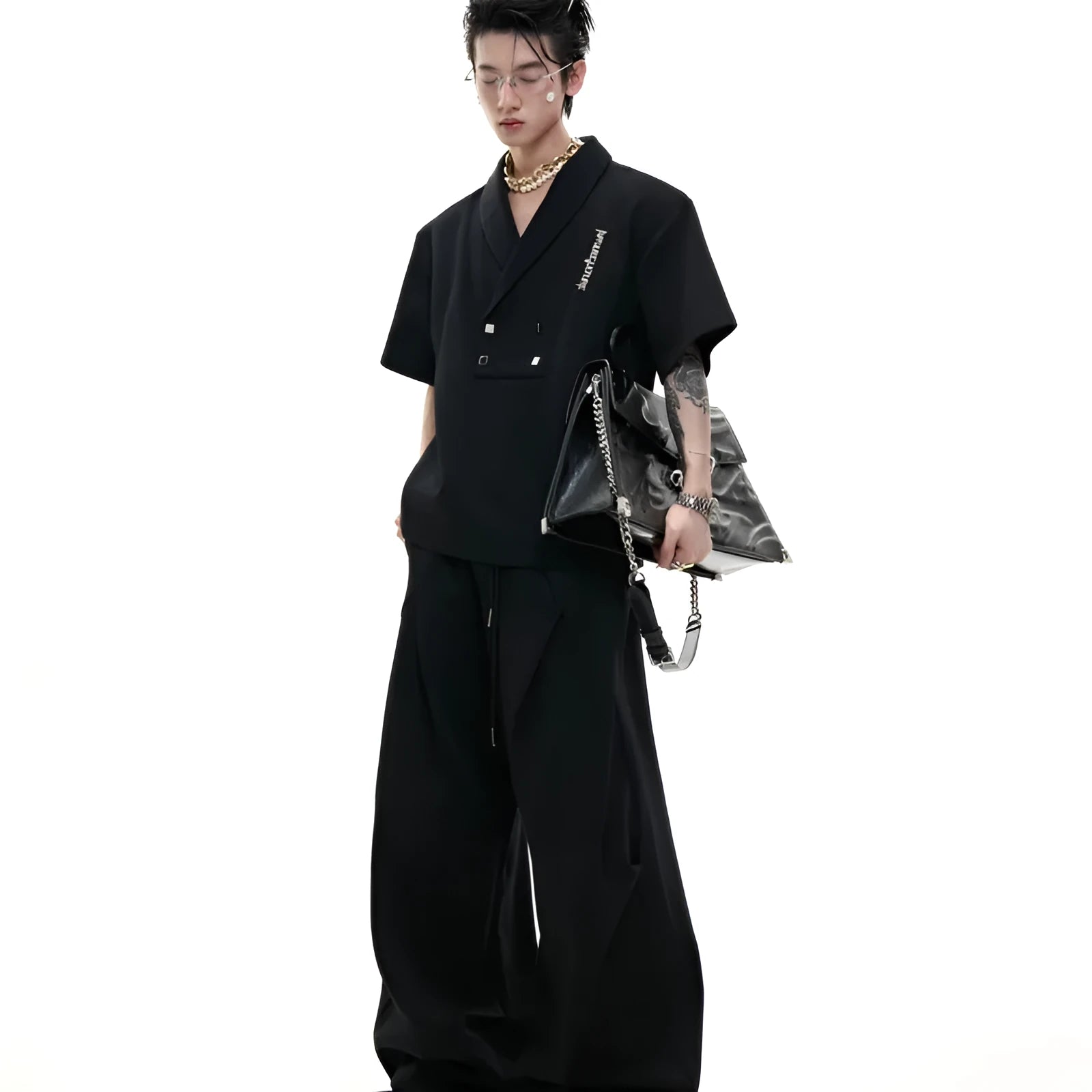 Men's dark grey V-neck cotton sports jacket with padded shoulders and metal detail, worn with matching shorts