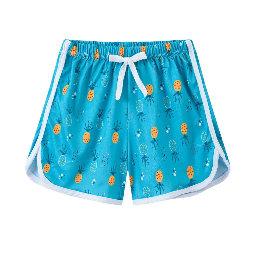 Children's solid-colour beach shorts in various prints including leopard, stripes, and floral patterns.