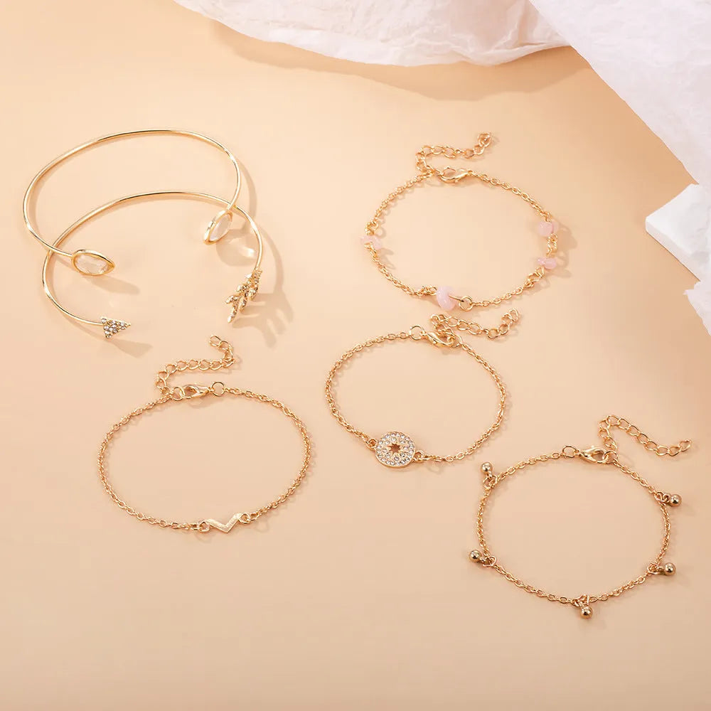 Gold tone six piece women's bracelet set with water droplet and arrow designs