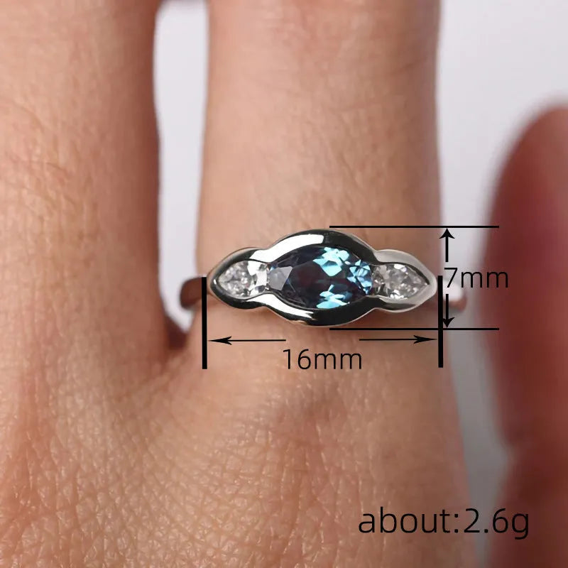 Geometric ellipse zircon ring in white gold colour showing structured design and stone inlay