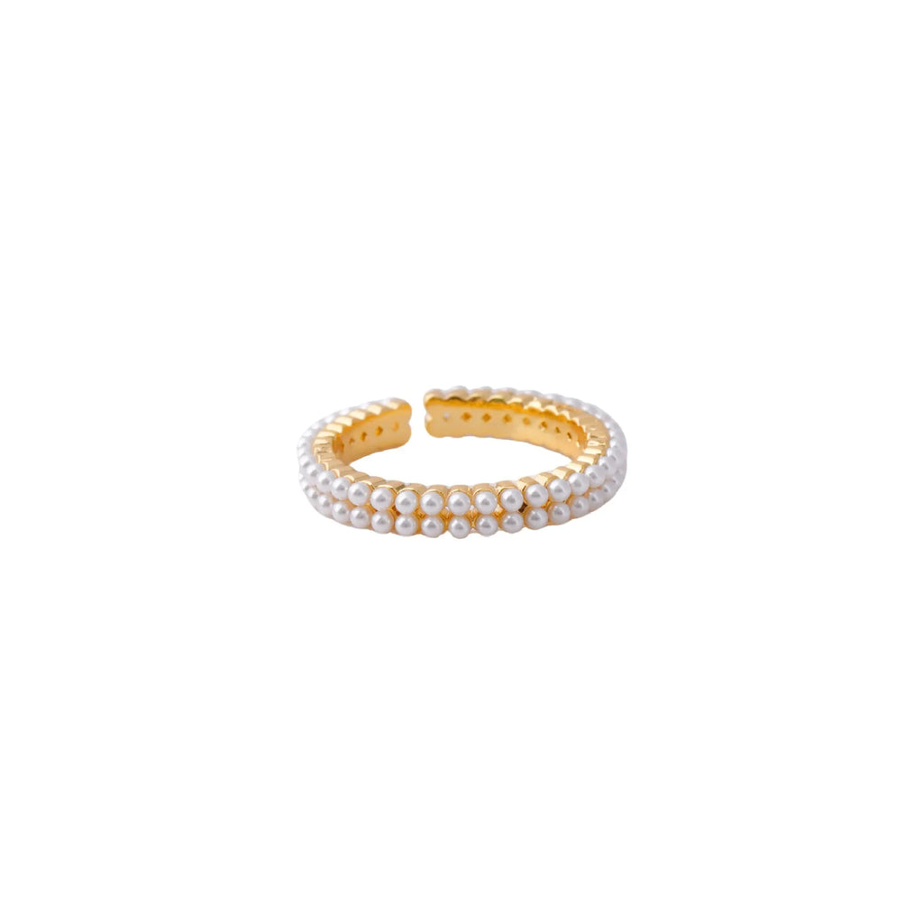 Gold geometric open ring with pearl detail on a model's finger.
