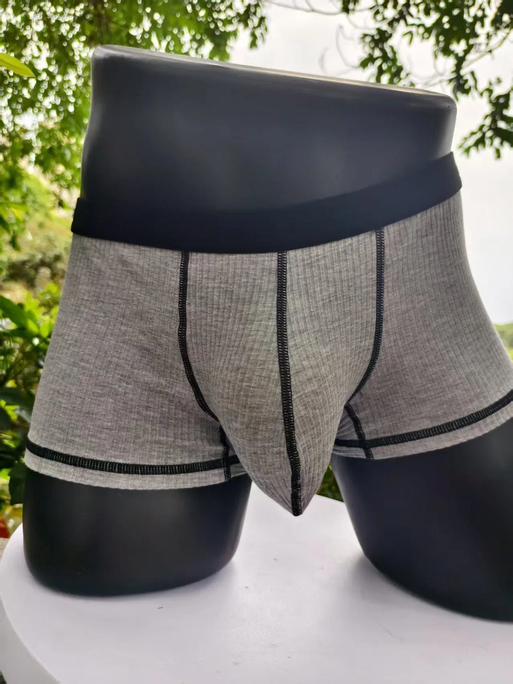 Men's solid colour boxer shorts in breathable fabric on a size chart showing L, XL, 2XL, and 3XL.