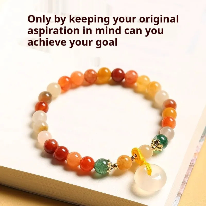 Handmade natural jinsi jade and red agate peace clasp bracelet with safety buckle on wrist.