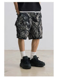 Army green loose fit straight-leg denim shorts with a mid waist and zip fly on a hanger.